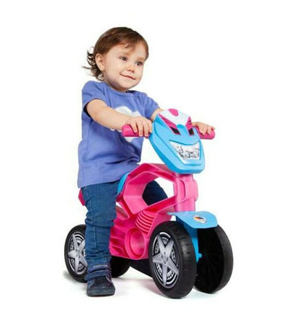 Moltó Loopmotor Moltó 21201 pink ride-on toy for children, 53 cm, in a playful outdoor setting with colorful background.