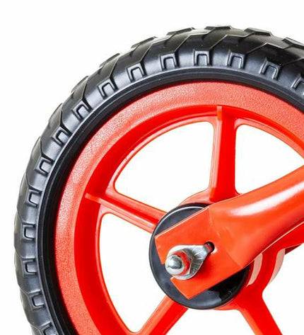Moltó red children's balance bike with training wheels, suitable for outdoor play and learning to ride.
