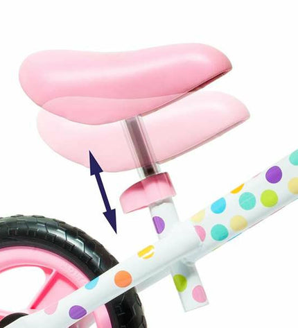 Pink toddler balance bike by Moltó with no pedals, perfect for outdoor play and early cycling development.