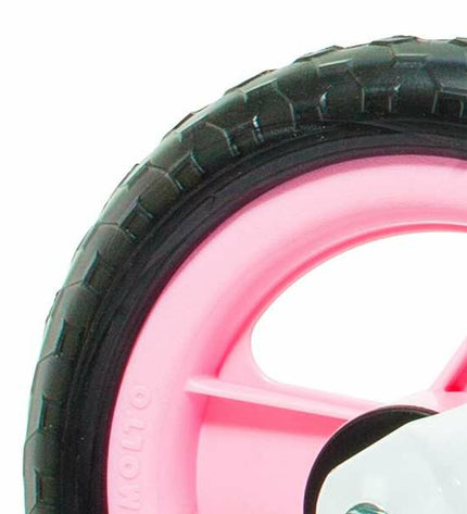 Pink toddler balance bike by Moltó, no pedals, ideal for young children learning to ride, suitable for outdoor play.