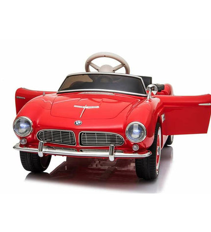 Red Injusa BMW 507 electric toy car for kids, designed for outdoor play and sports, with detailed exterior and realistic features.