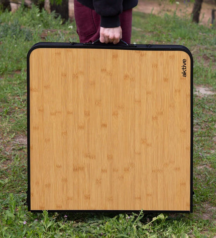 Aktive Tafel Aktive for outdoor activities, camping, and hiking, showing a durable, compact camping table in natural setting.