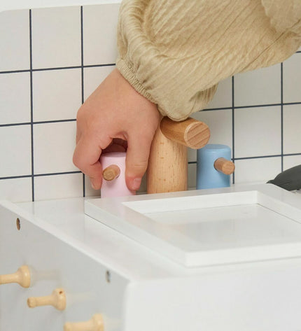 Teamson wooden toy kitchen with realistic stove, sink, and storage compartments, designed for imaginative play in children's playroom.