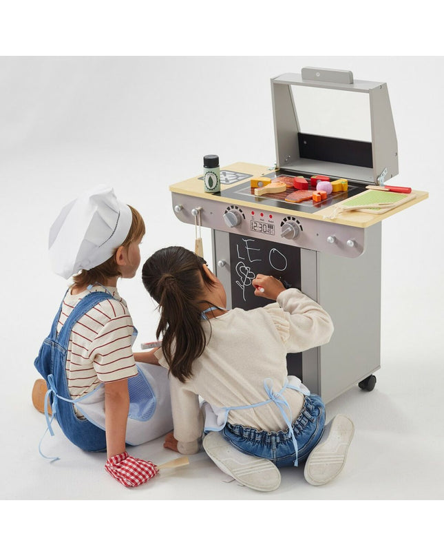 Teamson toy play kitchen BBQ set with stove, countertop, and accessories in a colorful pretend kitchen scene.