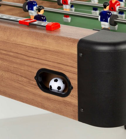 CB Games tabletop foosball game in black and green, measuring 121x81x61 cm, with miniature players and rods for fun gameplay