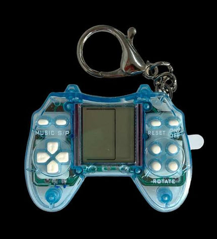Portable Comansi gaming console for kids, featuring colorful buttons and a compact electronic toy design.