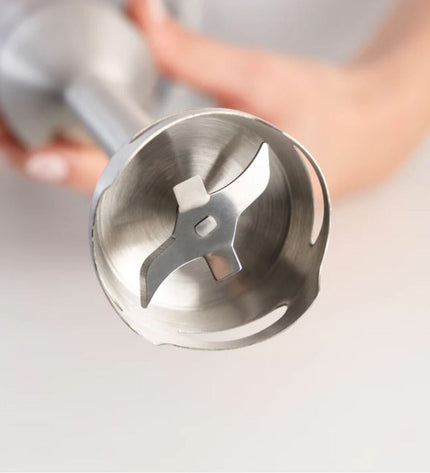 Taurus HBA1700X black handheld mixer with beaters and control dial, used for baking and cooking tasks.