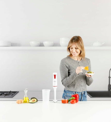 Taurus ROBOT750 hand blender with 750W motor, featuring a sleek design and blending attachments for kitchen use.