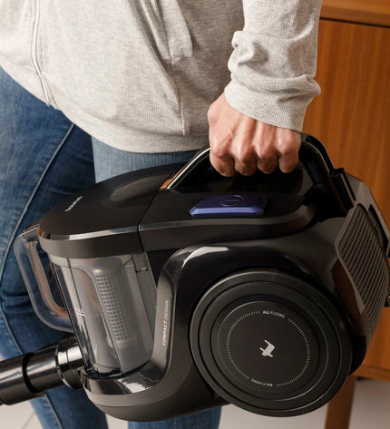 Taurus Guzzler Cyclone 850W steel vacuum cleaner with hose and attachments for home cleaning and floor maintenance.
