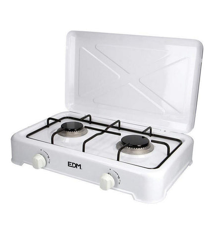 EDM gas stove for camping and outdoor use, compact 46x30x12 cm with four burners and control knobs, in a natural outdoor setting.