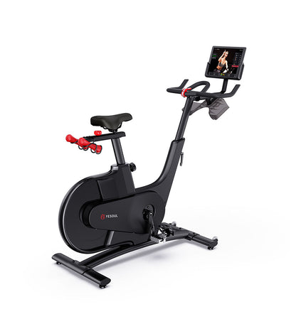 Yesoul Professional V1 stationary exercise bike with Bluetooth 5.0, refurbished, in a fitness and outdoor sport setting.