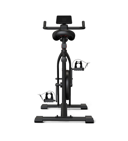 KSIX Bluetooth stationary bike in a fitness and outdoor setting, showcasing the modern design and digital display.