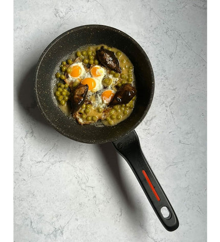 Fagor Alutherm 26cm black frying pan for cooking, with a sturdy handle and non-stick surface on a kitchen countertop.