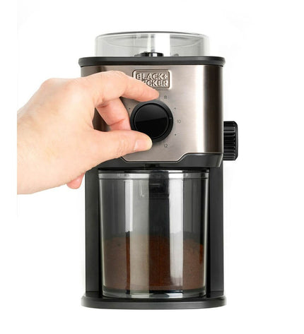 Black & Decker BXCG151E coffee grinder in black with a clear lid, showing the grinding chamber and control switch.