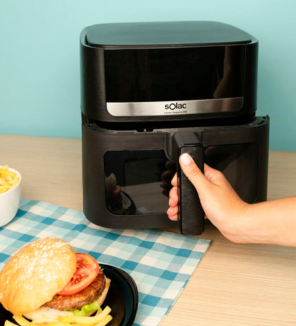 Black Solac FA1801 air fryer for home cooking, compact electric kitchen appliance with digital controls.