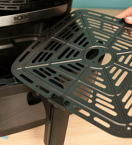 Black Solac FA1801 air fryer shown on kitchen countertop with digital display and compact design for easy home cooking.