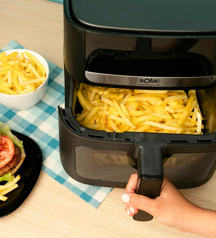 Black Solac FA1801 air fryer for home cooking, compact electric kitchen appliance with digital display and basket.