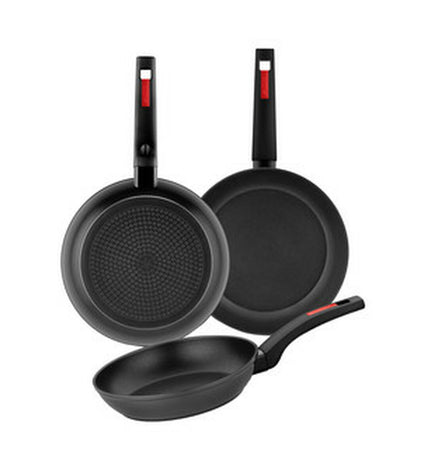 Black plastic Monix M249001 3-piece pan set for kitchen and home cooking, with visible handles and lid components.