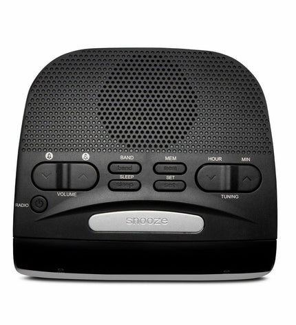 Aiwa CR-15 black radio alarm clock with digital display and control buttons, placed on a bedside table.