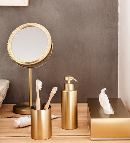Andrea House toilet brush in gold with a sleek handle, designed for bathroom cleaning and home hygiene.