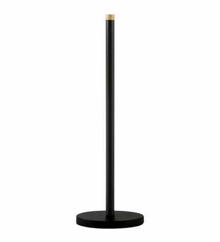 Black metal Andrea House toilet paper holder mounted on bathroom wall, featuring a sleek, modern design for bathroom decor.