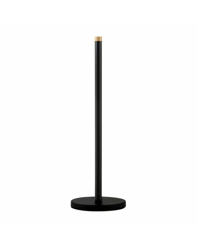 Black metal Andrea House toilet paper holder mounted on bathroom wall, featuring a sleek, modern design for bathroom decor.