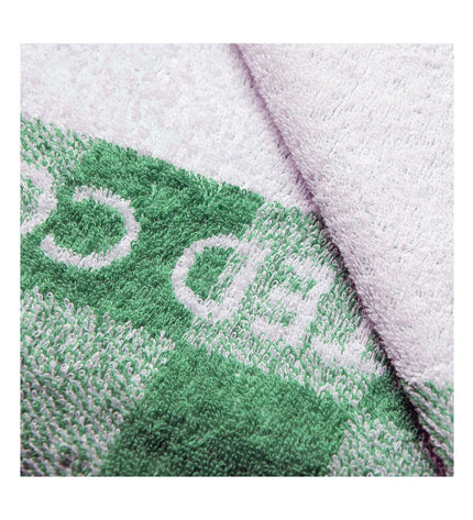 Benetton green beach towel with 140x170 cm size, featuring a soft, absorbent fabric for home and bath use.