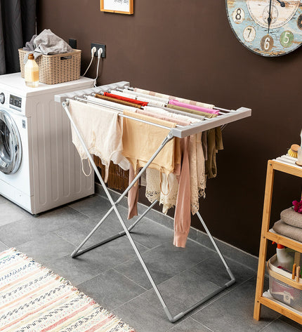 InnovaGoods foldable electric clothes drying rack with 8 bars, 120W, in a home laundry setting.