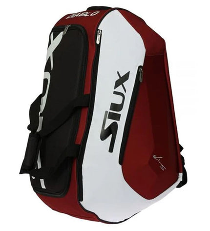 Siux Diablo Rood paddle tennis racket in red with black accents, shown on a sports outdoor court.