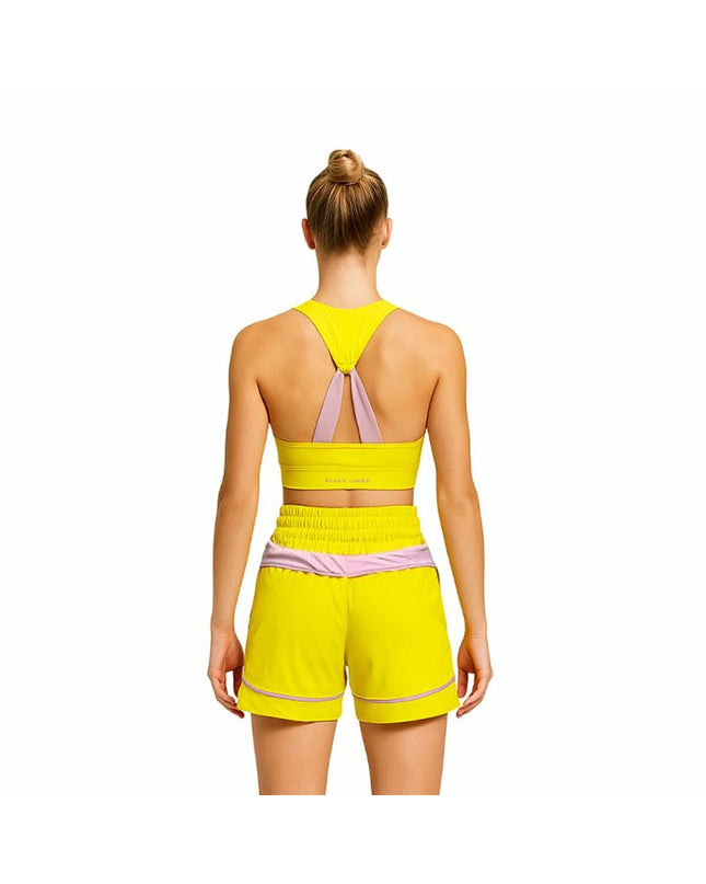 Black Limba yellow sports top for women, ideal for fitness and dance, shown on a model against a neutral background.