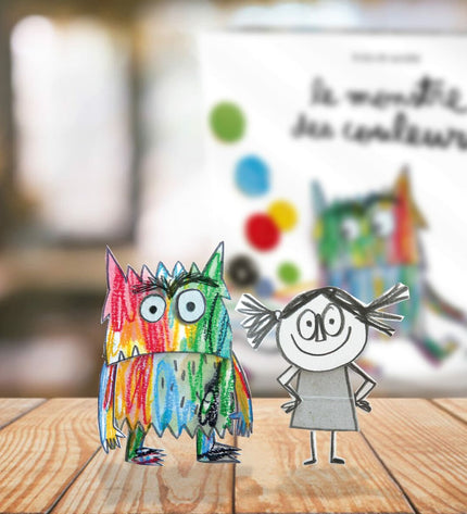 Colorful board game "El Monstruo de Colores" by Devir featuring vibrant monster characters and game pieces on a table.