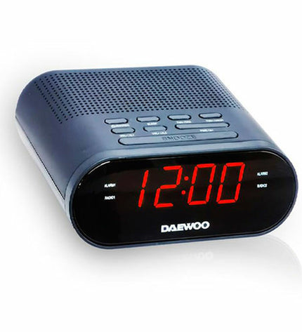 Daewoo DW1218 black radio alarm clock with digital display and control buttons, electronic audio and hi-fi device.