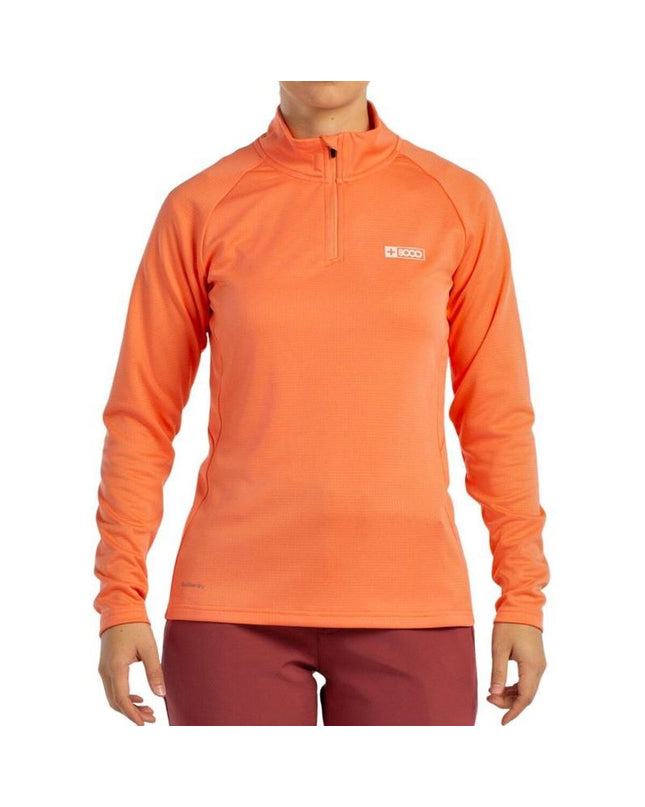 Orange long-sleeve women's T-shirt from +8000 for outdoor activities, shown on a model in a camping or hiking setting.