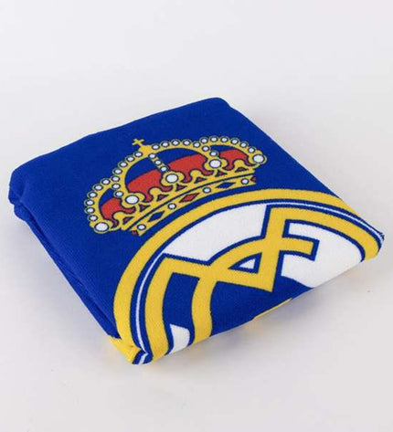 Real Madrid C.F. blue hooded poncho towel, 55 x 77 cm, designed for home and bathroom use, featuring team logo and soft fabric.