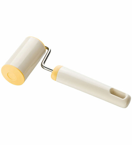 Plastic deegroller Tescoma Delicia for baking and cooking, shown resting on a wooden surface with dough underneath.
