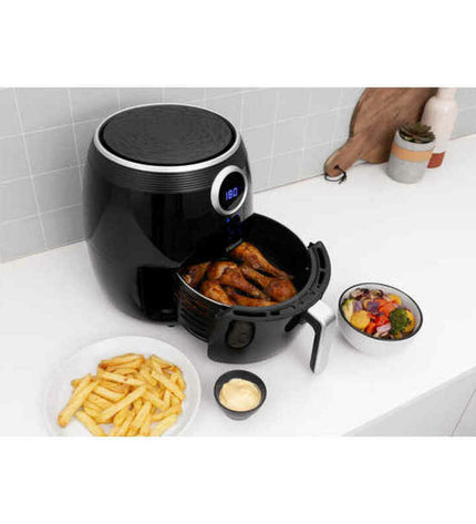 Black Tristar FR-6956 air fryer with 1500W power, compact kitchen appliance for healthy frying, shown with basket and control panel.