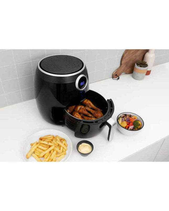 Black Tristar FR-6956 air fryer with 1500W power, compact kitchen appliance for healthy frying, shown with basket and control panel.
