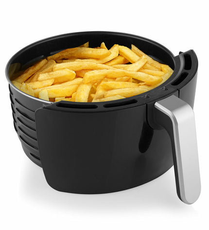 Black Tristar FR-6956 air fryer with 1500W power, compact design, and control panel for home cooking in kitchen.