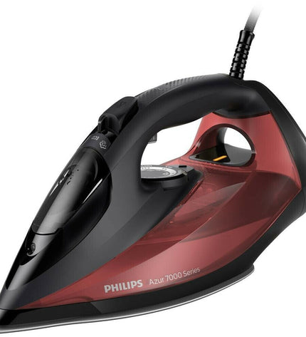 Philips DST7022/40 steam iron with digital display and ergonomic handle, placed on a white ironing board.