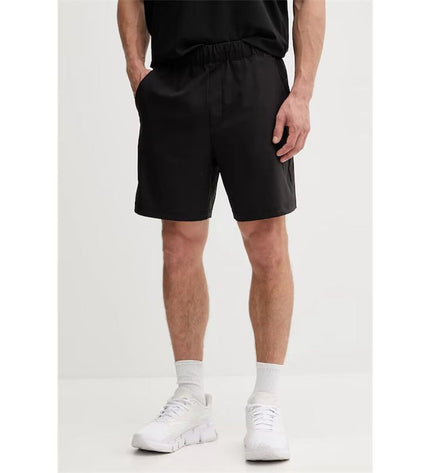 Black men's Calvin Klein woven swim trunks for sport and watersports, featuring a comfortable fit and sleek design.