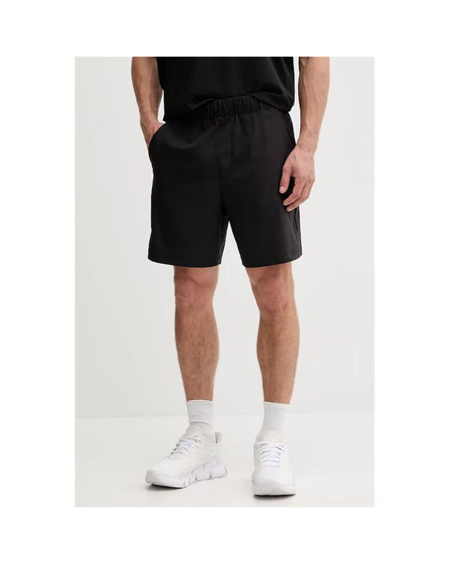 Black men's Calvin Klein woven swim trunks for sport and watersports, featuring a comfortable fit and sleek design.