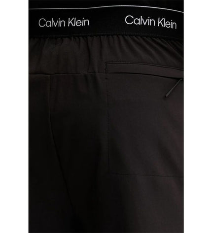 Calvin Klein men's black woven swim shorts for sport and watersports, featuring a sleek, modern design.
