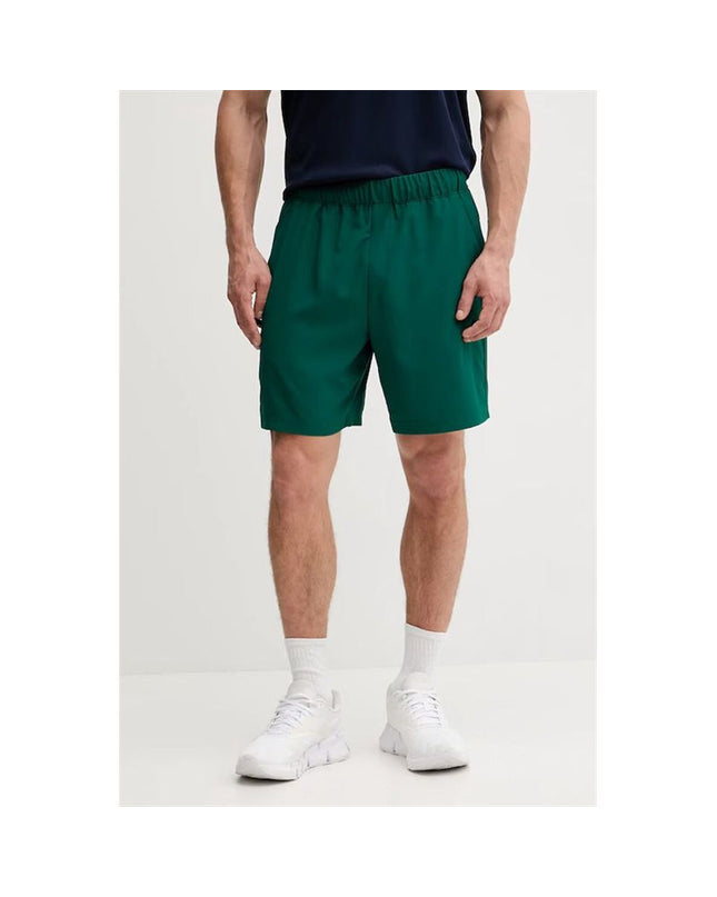Calvin Klein men's woven green swim trunks for sports and watersports, with a close-up view of the fabric and waistband.