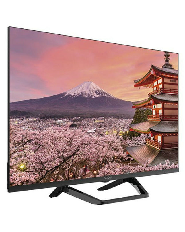 Strong SRT32HG6733C 32-inch HD Smart TV displaying a colorful home entertainment scene with a sleek black frame.