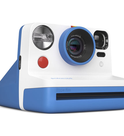 Polaroid instant camera in blue with dimensions 11.2 x 9.4 x 15 cm, showcasing its compact design and vintage camera features.