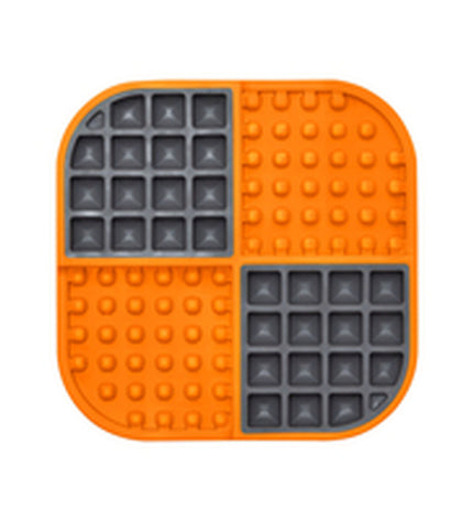 Orange Lickimat dog feeder made of polypropylene and TPR, designed for dogs to lick and engage, part of Lickimat's pet products.