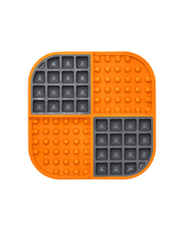 Orange Lickimat dog feeder made of polypropylene and TPR, designed for dogs to lick and engage, part of Lickimat's pet products.