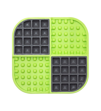 Green Lickimat dog feeder made of durable polypropylene and TPR, designed to slow dogs' eating and provide mental stimulation.