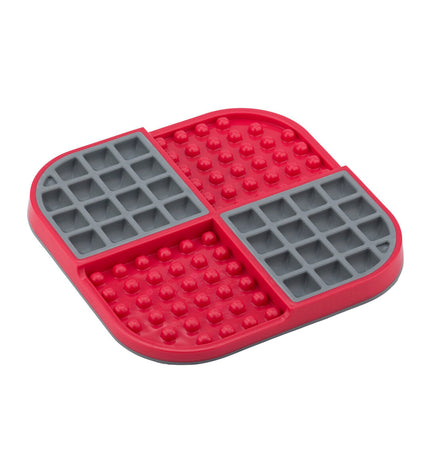 Red Lickimat dog feeding bowl made of polypropylene and TPR, designed for dogs to lick and play with.