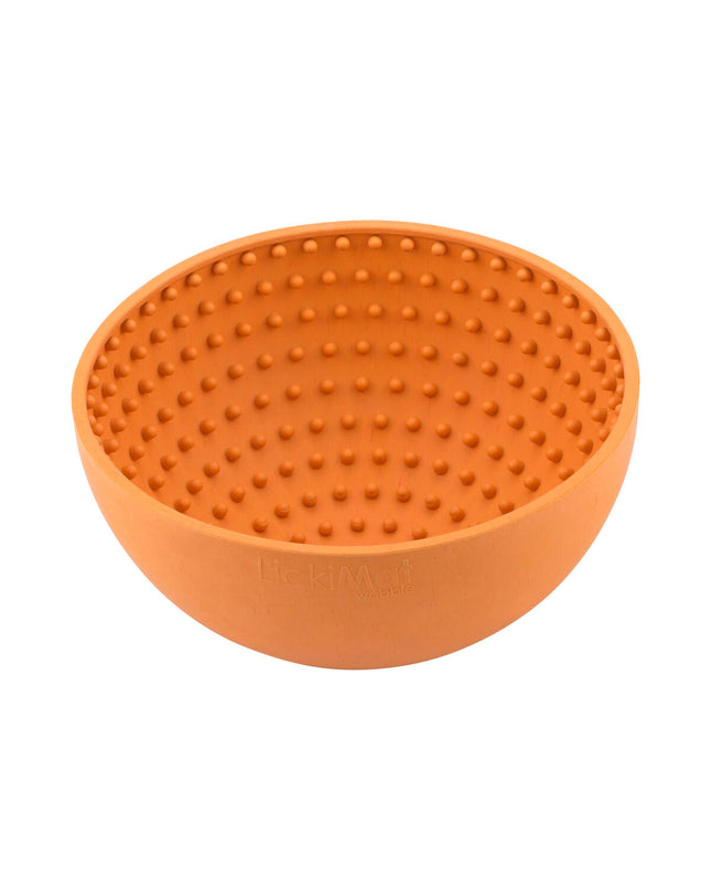 Orange rubber dog lickimat wobble feeder with textured surface, designed for dog enrichment and interactive feeding.